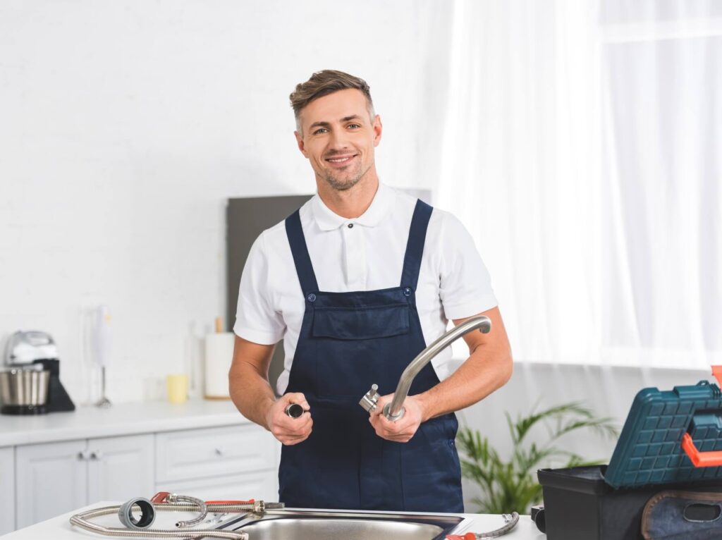 smiling adult repairman taking off kitchen faucet 2024 11 19 04 07 34 utc.jpg